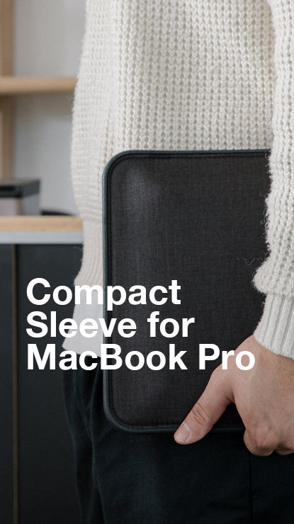 person holding incase compact sleeve for macbook pro