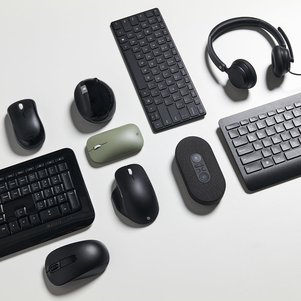 multiple Microsoft accessories laying flat in a group photo - mobile size image